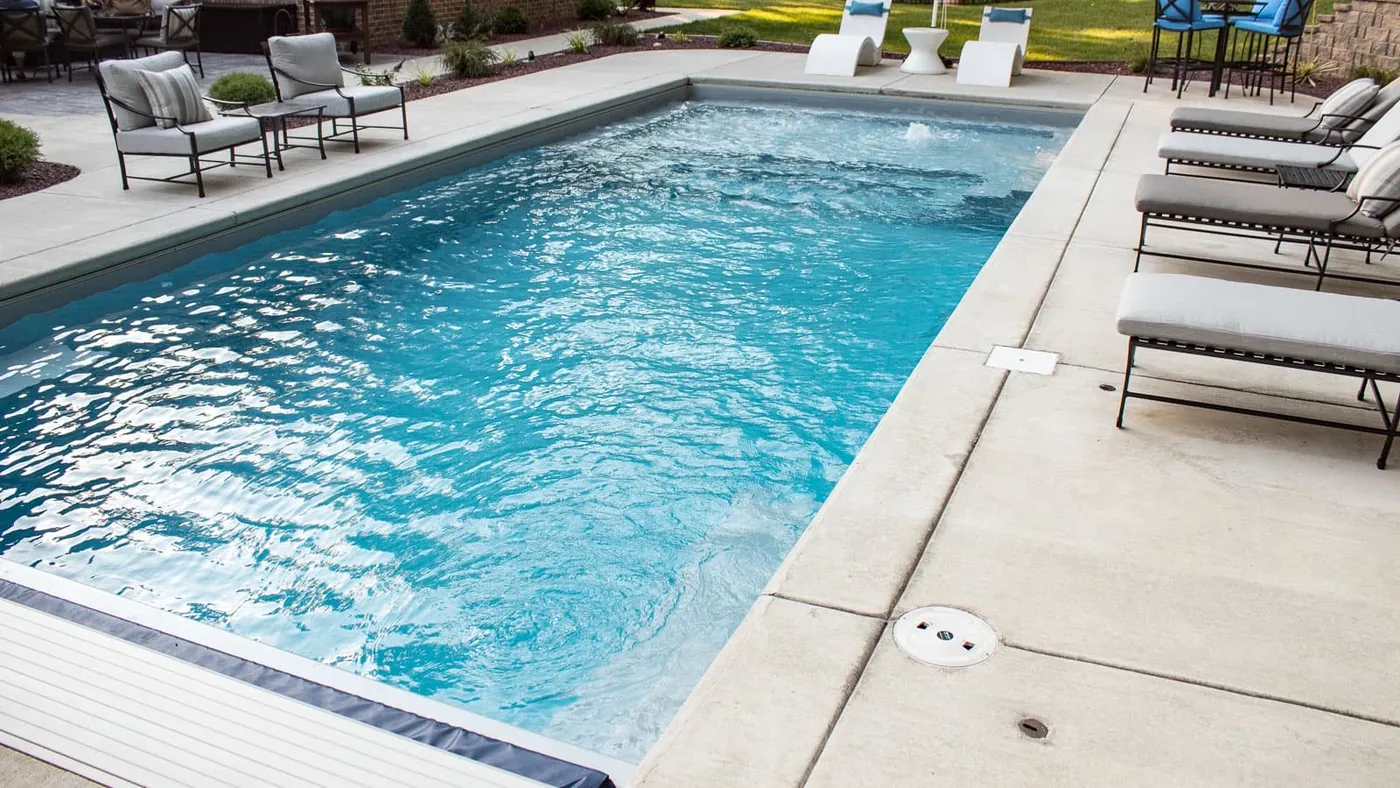 Fiberglass pool with automatic cover in an Oklahoma backyard