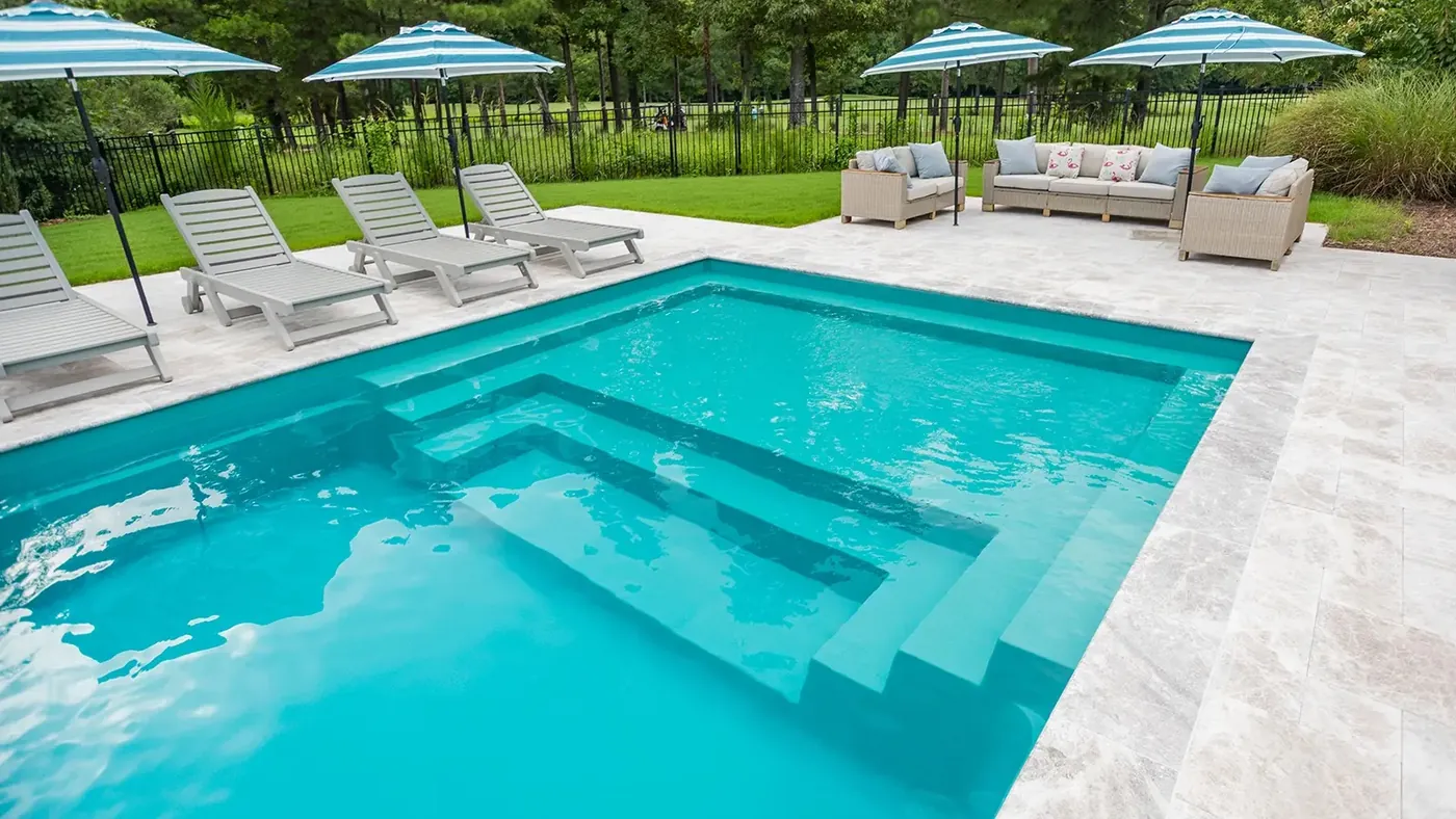 Fiberglass pool entry steps in turquoise water